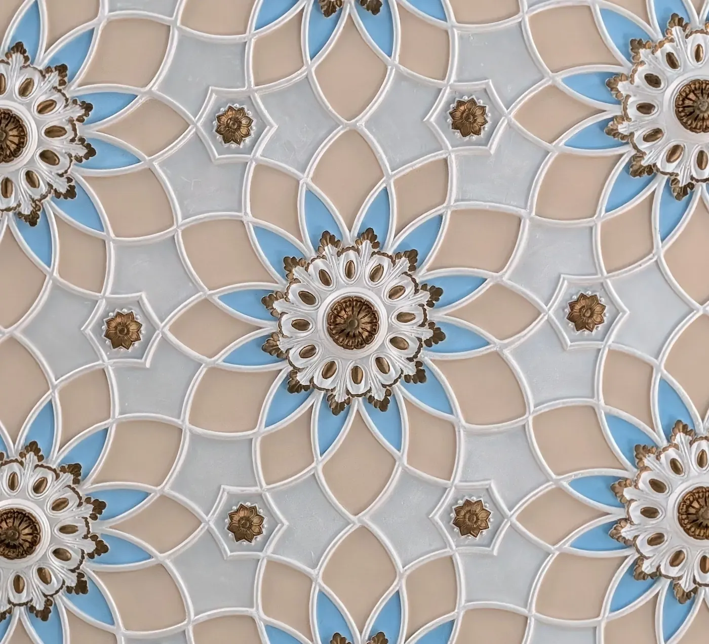 Detailed blue, beige and gold geometric medallion pattern
